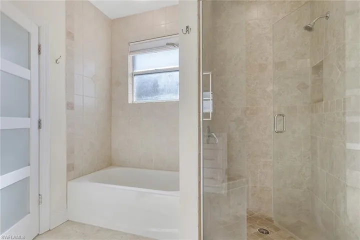 Bathroom with a stall shower and a garden tub