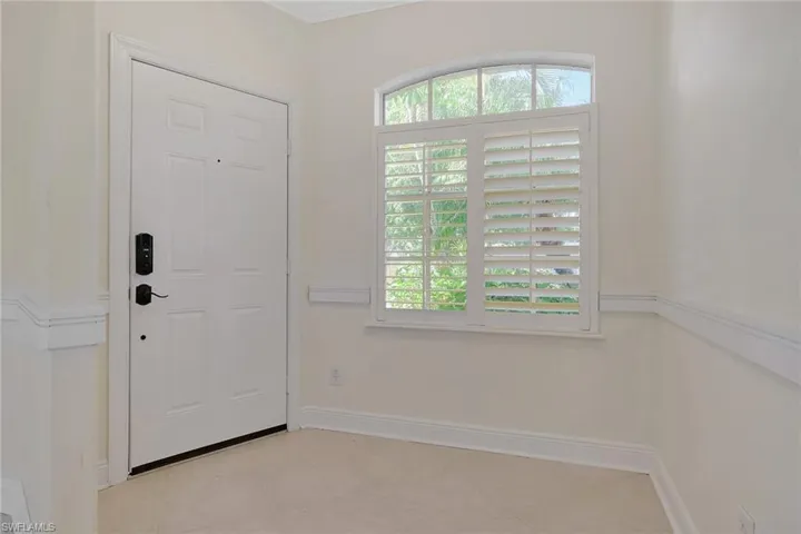 Foyer entrance featuring baseboards