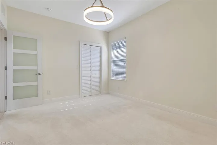 Unfurnished bedroom with carpet flooring and a closet