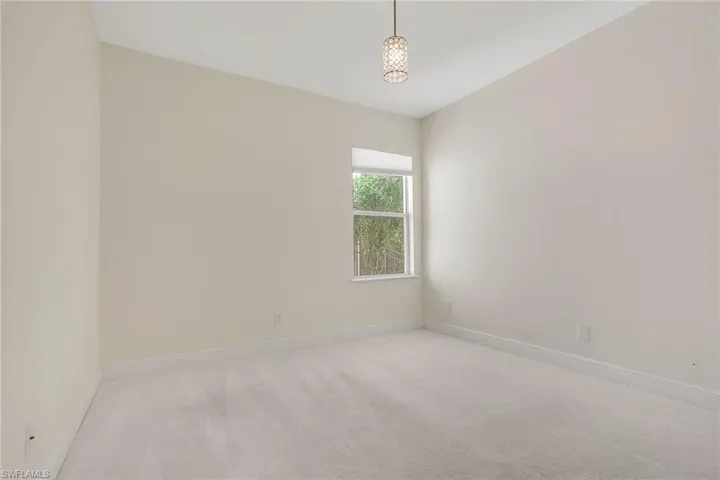 Spare room featuring carpet floors and baseboards