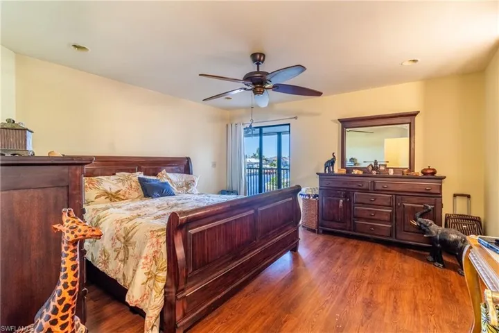 Bedroom with ceiling fan and dark hardwood / wood-style floors