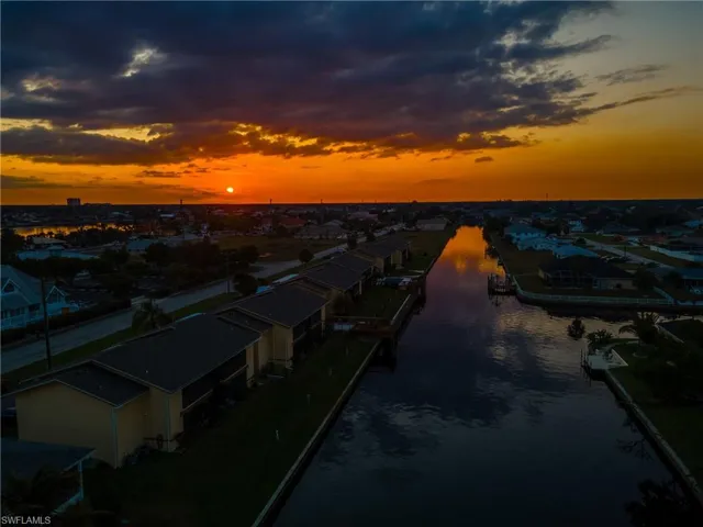 Aerial view at dusk featuring a water view