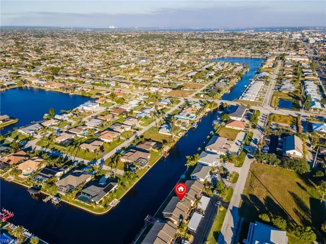 Birds eye view of property with a water view