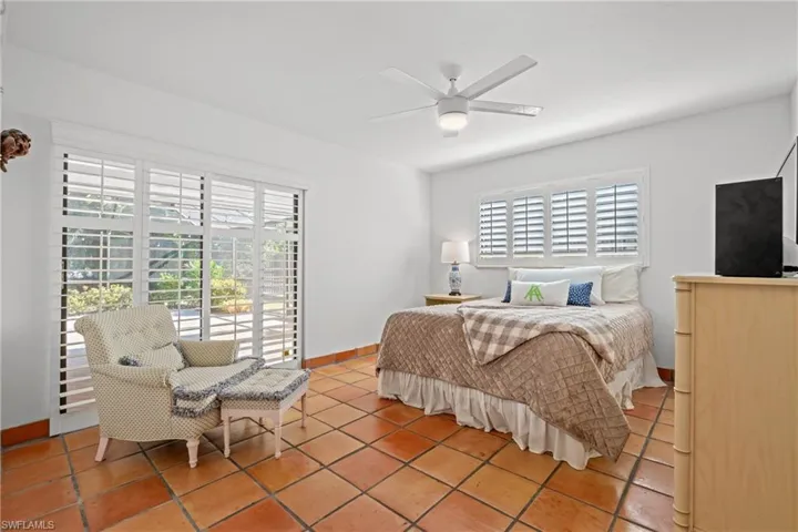Bedroom featuring ceiling fan and baseboards