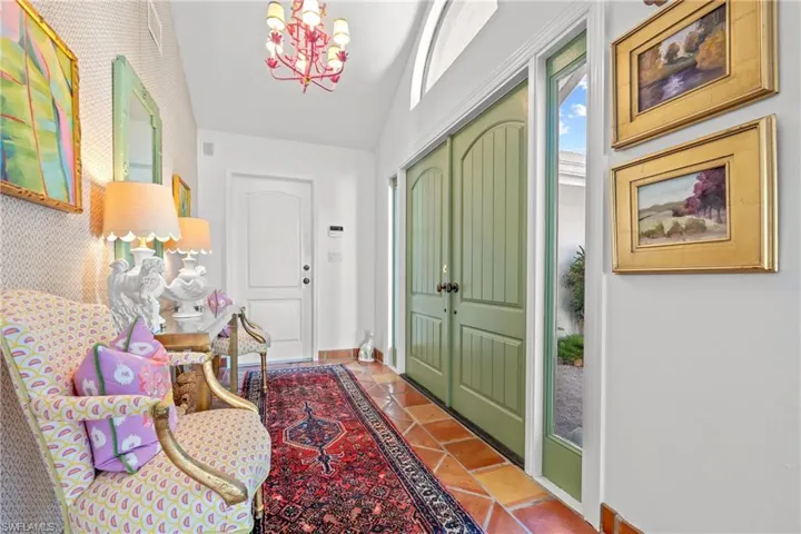 Foyer entrance featuring a chandelier and lofted ceiling