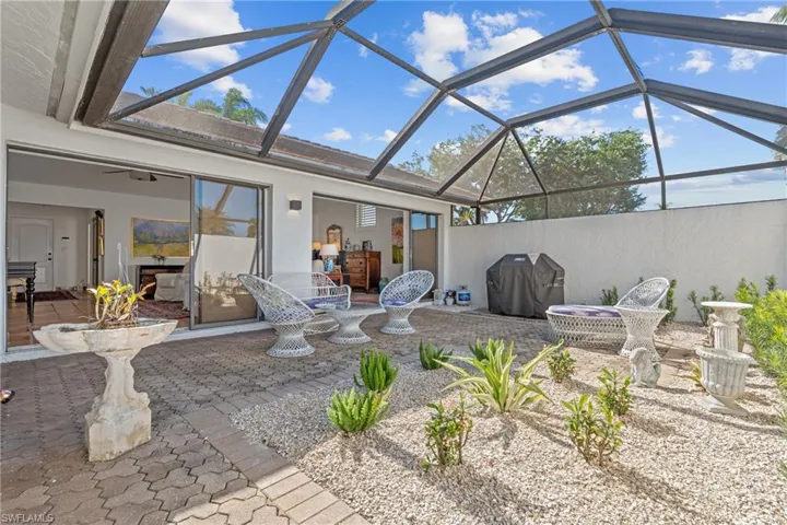 View of patio / terrace featuring glass enclosure, area for grilling, and a sunroom