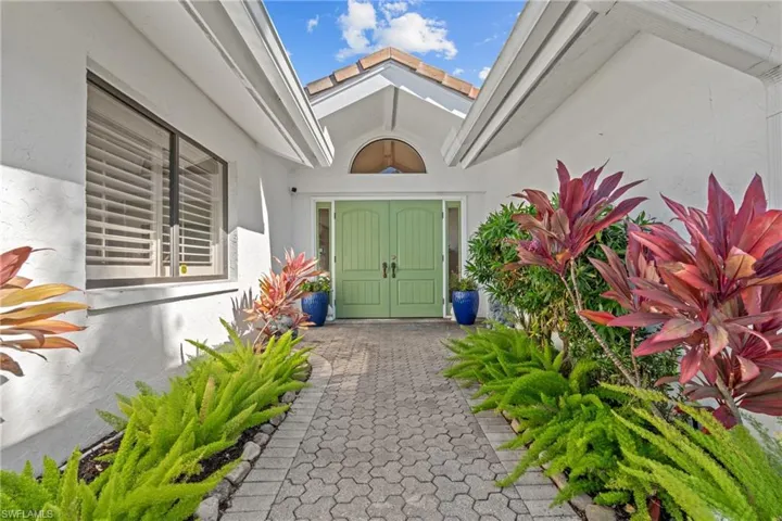 Property entrance featuring stucco siding