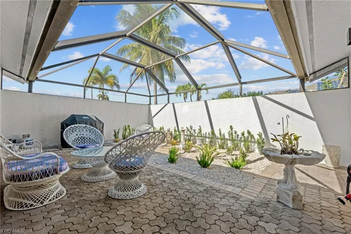 View of patio with a lanai and a sunroom