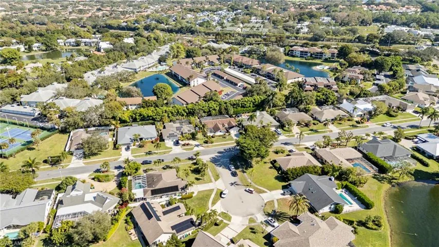 Aerial view of property's location with a large body of water and nearby suburban area