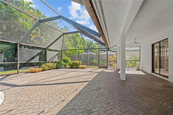 View of patio / terrace featuring a lanai, a sunroom, and ceiling fan
