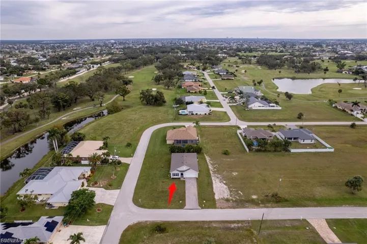 Aerial view of property's location featuring nearby suburban area and a nearby body of water