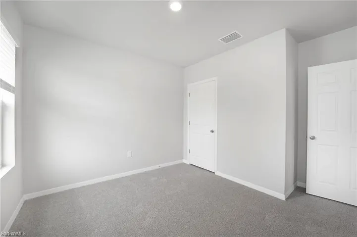 Unfurnished bedroom with carpet floors