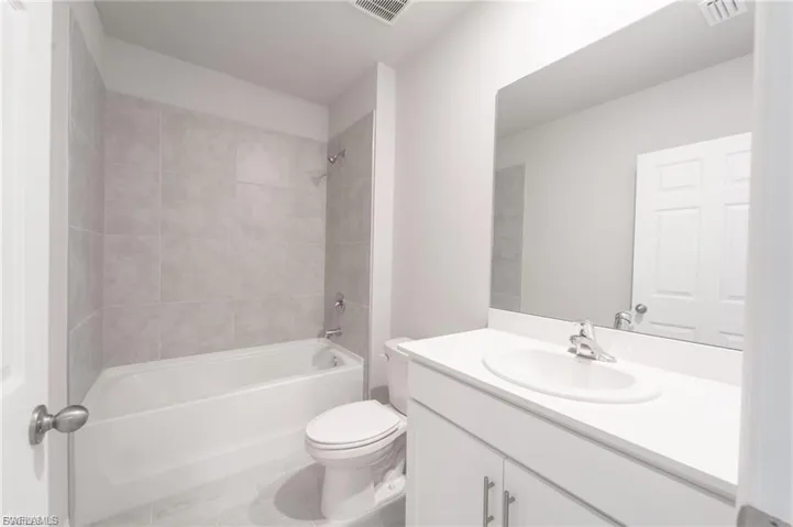 Full bathroom with shower / tub combination and vanity