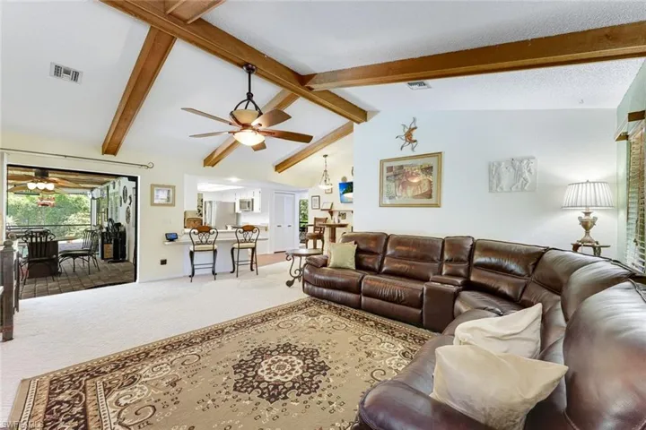 Living area with carpet floors and ceiling fan