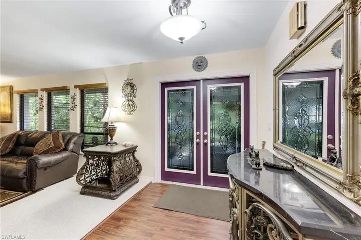 Foyer entrance with wood finished floors and french doors