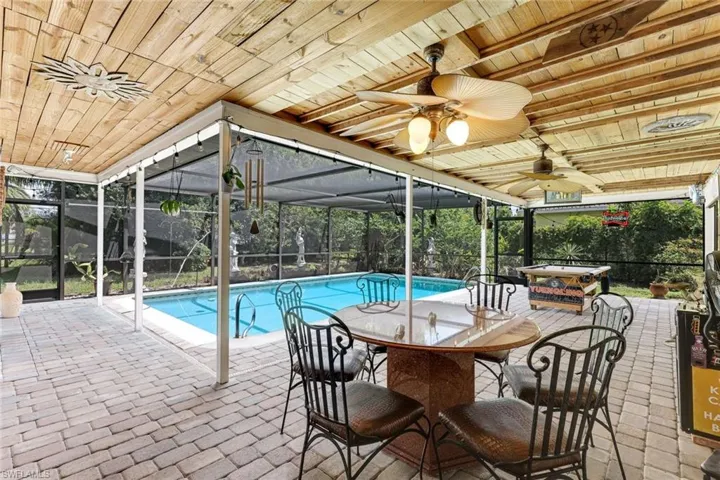 Outdoor pool featuring ceiling fan, a patio, and outdoor dining area