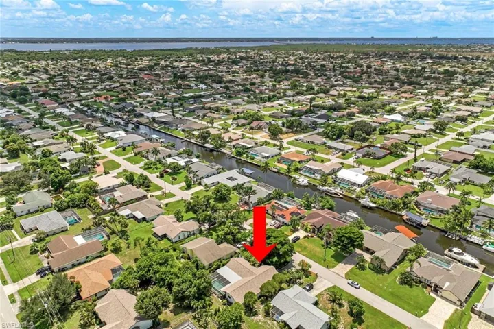 Aerial perspective of suburban area featuring a large body of water