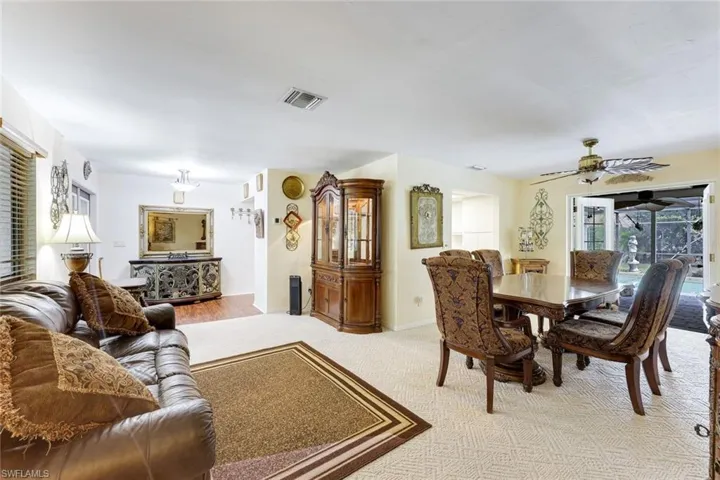 Dining room with ceiling fan and light carpet