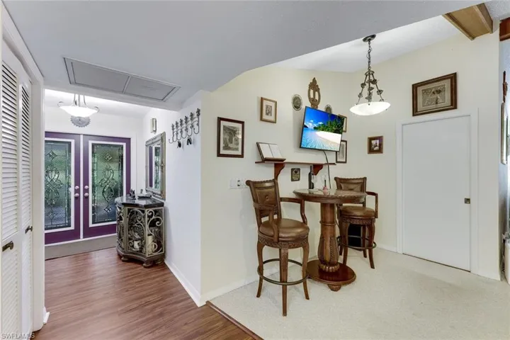 Hallway with french doors and wood finished floors