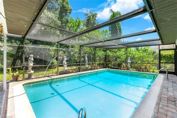 Outdoor pool with glass enclosure