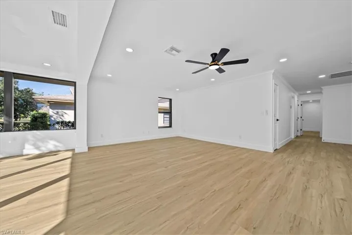 Unfurnished living room with recessed lighting, light wood finished floors, a ceiling fan, and ornamental molding