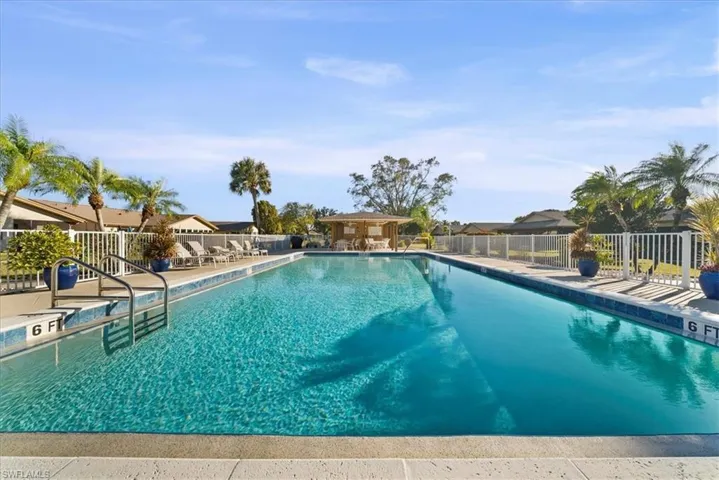 Community pool featuring a patio area, a gazebo, and a residential view