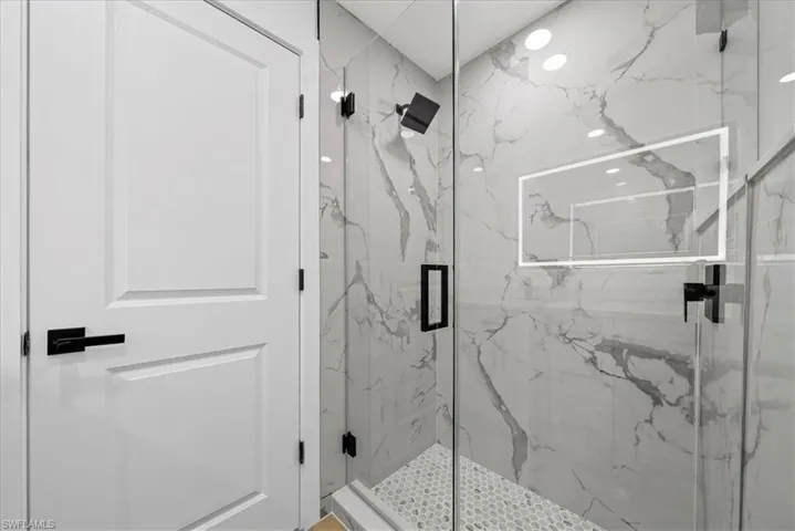 Bathroom featuring a marble finish shower