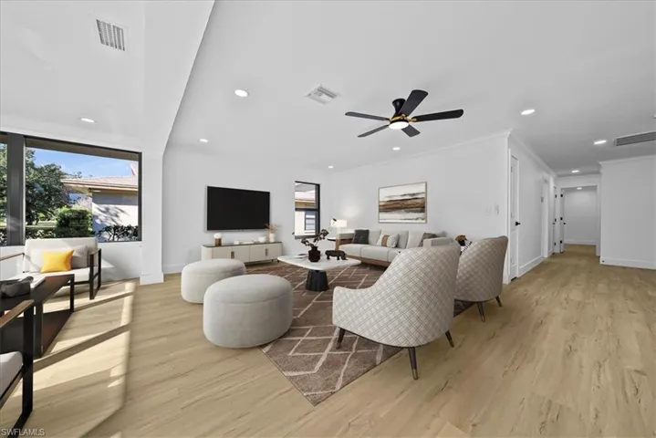 Living area featuring recessed lighting, light wood-style floors, plenty of natural light, a ceiling fan, and crown molding