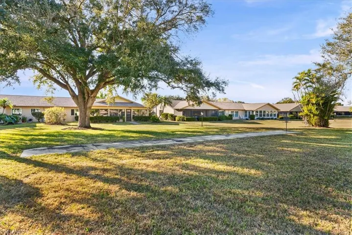 View of green lawn with a residential view