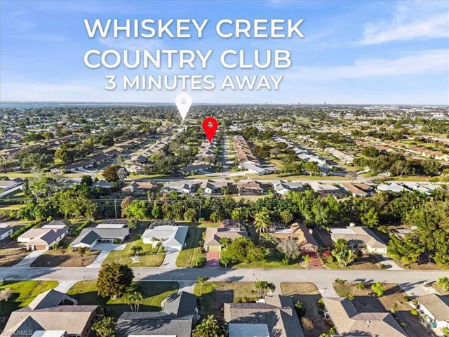Aerial view of property and surrounding area with nearby suburban area