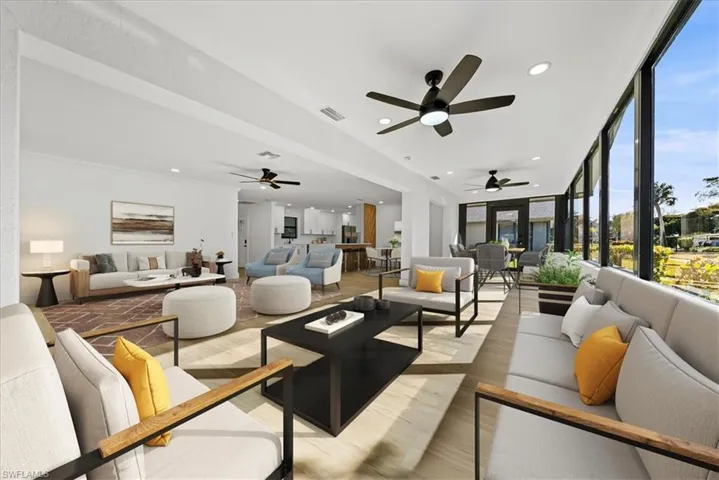 Living room with light wood-style flooring, recessed lighting, and a ceiling fan