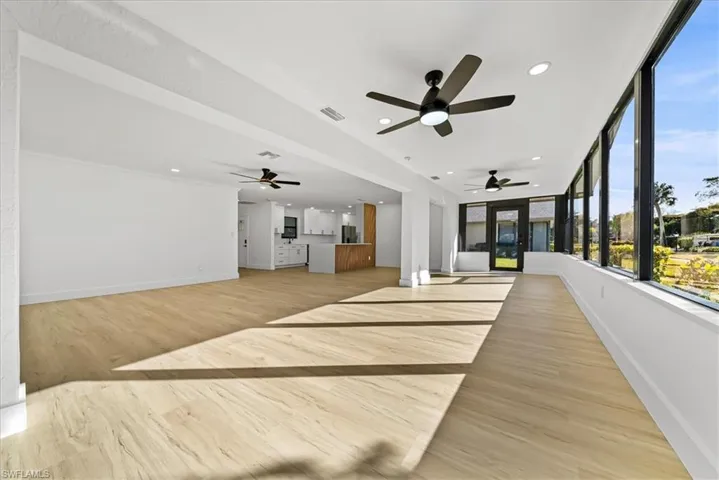 Unfurnished bedroom with light wood-style floors, recessed lighting, and fridge with ice dispenser