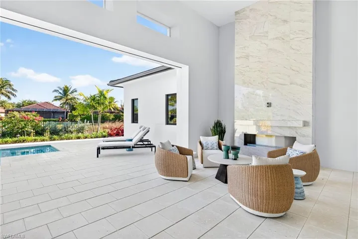 Patio seating area with gorgeous marble mantel and gas fireplace