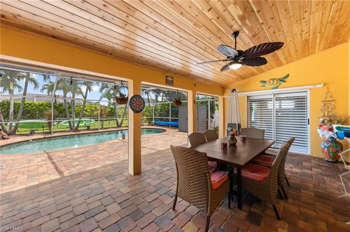 View of patio / terrace featuring a ceiling fan, an outdoor pool, and a lanai
