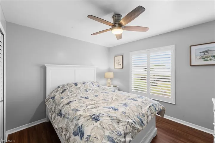 Bedroom with dark wood finished floors and ceiling fan