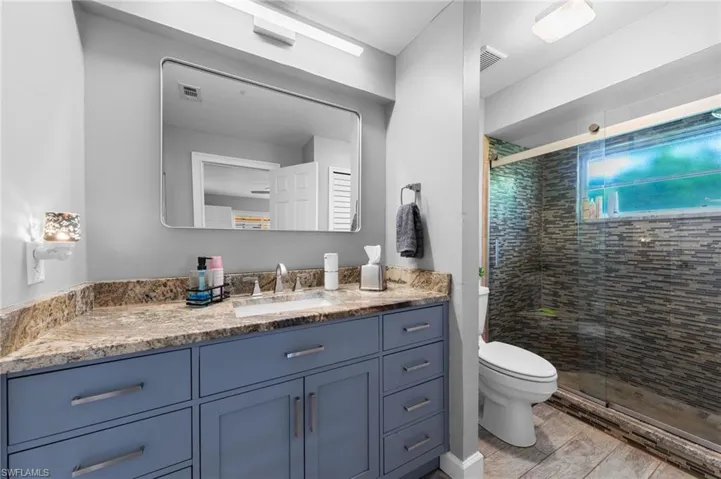 Full bath featuring vanity and a stall shower