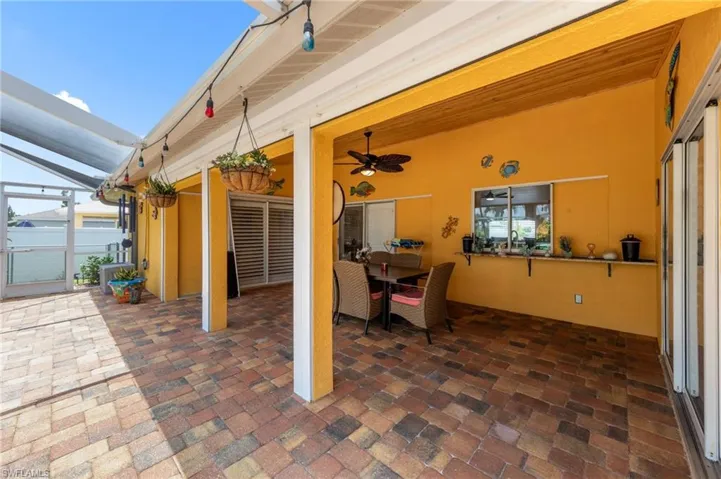 View of patio with a lanai and a ceiling fan
