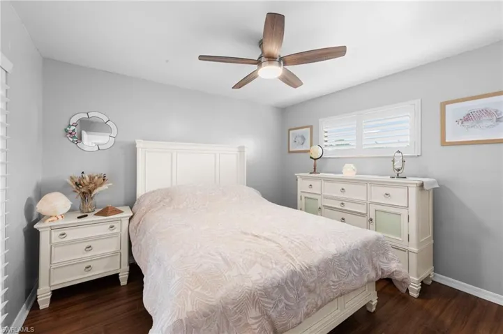 Bedroom featuring dark wood finished floors and a ceiling fan