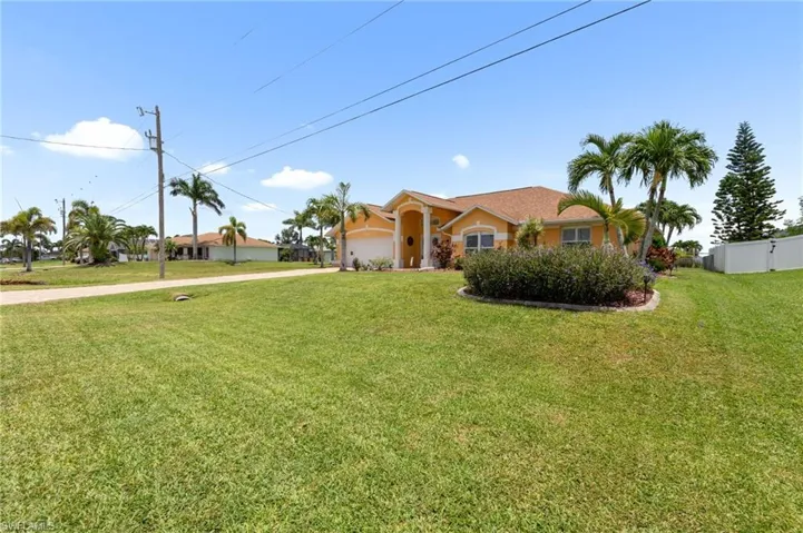View of front of home featuring concrete driveway, a garage, and stucco siding