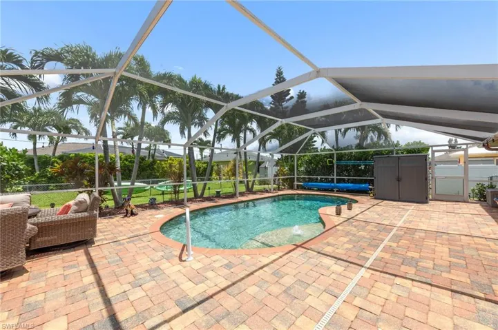 Swimming pool featuring a patio area and glass enclosure