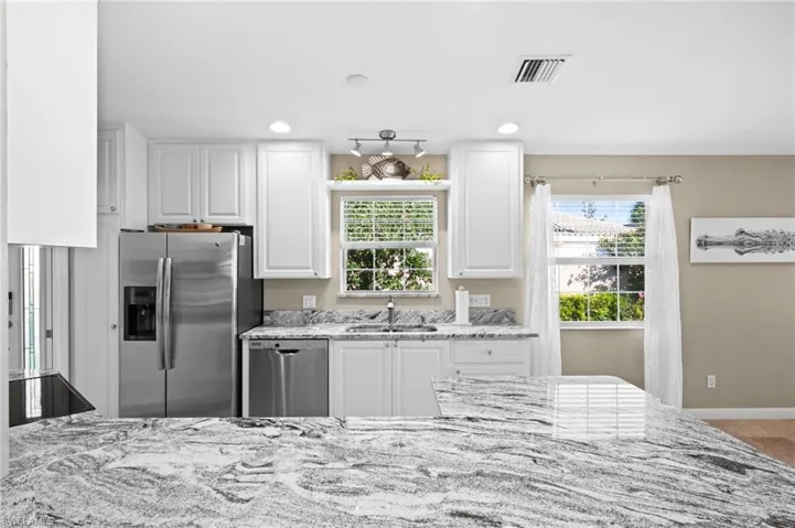 Well-appointed kitchen featuring stainless steel appliances, Carrara countertops.