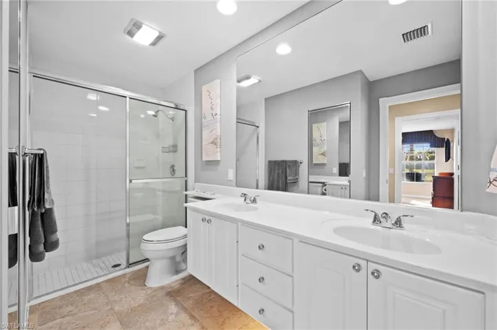 Well-designed primary bath with thoughtful details and under-vanity lighting.