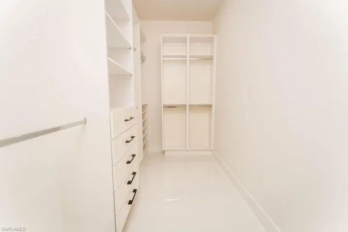 Spacious closet featuring light tile patterned flooring