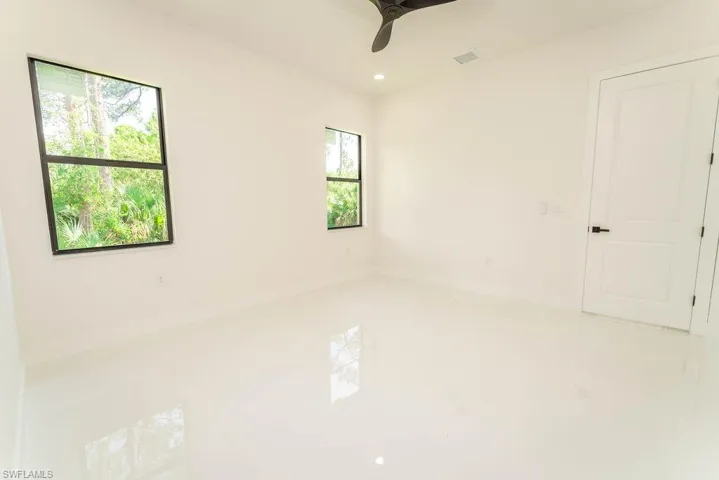 Tiled spare room with recessed lighting and a ceiling fan