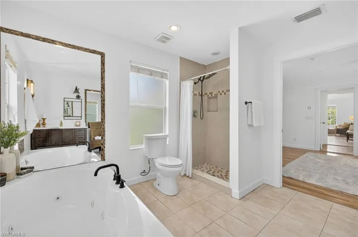 Master bathroom with dual sink, large jetted tub with a separate shower