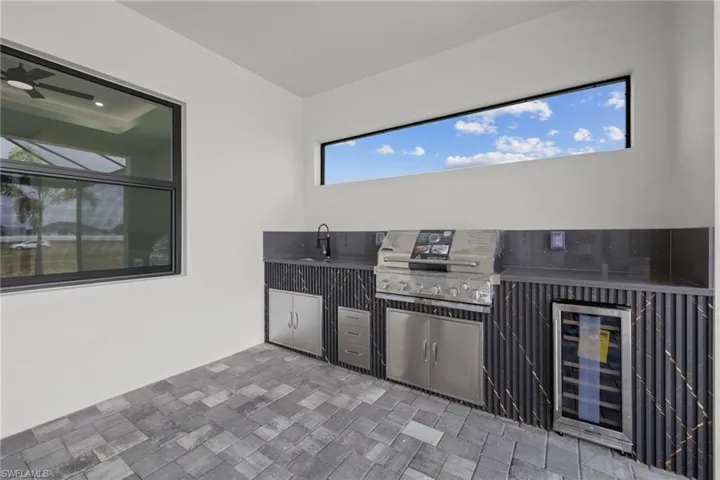 View of patio with wine cooler and a sink