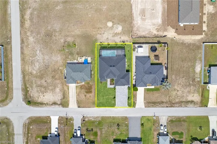 Aerial perspective of suburban area featuring property boundaries highlighted
