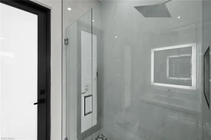 Bathroom featuring a marble finish shower