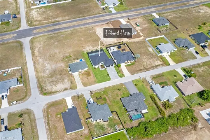 Aerial view of property and surrounding area with nearby suburban area