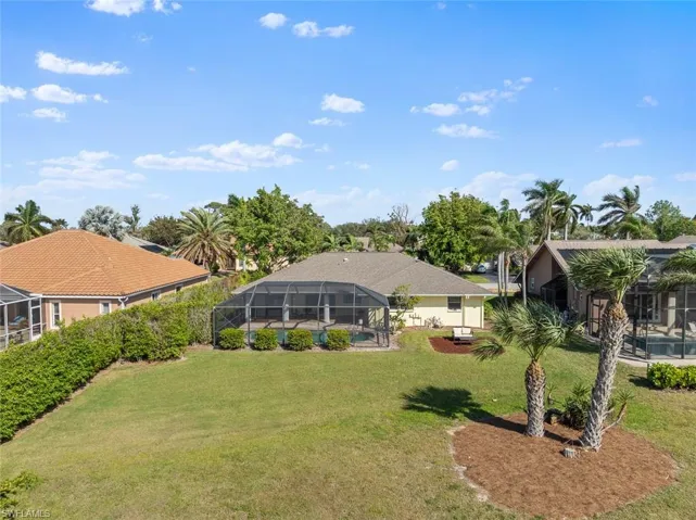 View of yard with a lanai and a swimming pool